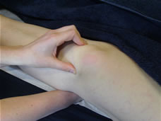 A Therapeutic Bowen move being performed on a knee
